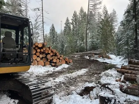 Log truck hauling a winter load of timber out of a small-tract job
